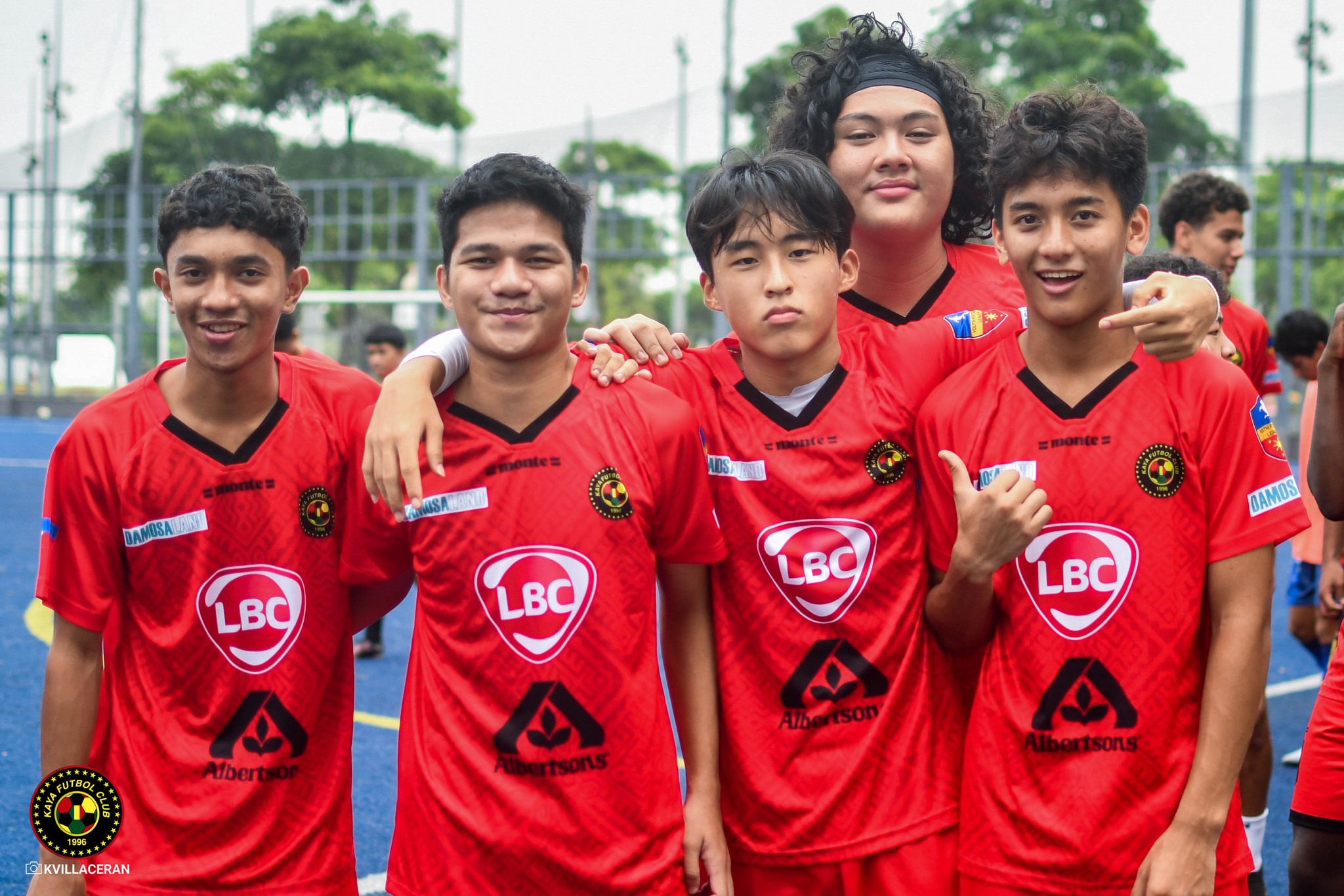 Kaya FC Academy students wearing football kit with logos of Damosa Land, LBC, Albertsons Philtech